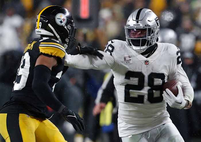 Las Vegas Raiders running back Josh Jacobs (28) carries the ball against Pittsburgh Steelers safety Minkah Fitzpatrick (39) during the third quarter at Acrisure Stadium in 2022. The Steelers won 13-10.
